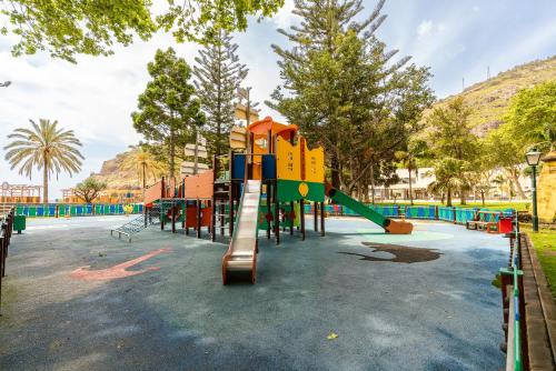 a playground with a slide in a park at Green Doors - AC and free parking in Machico