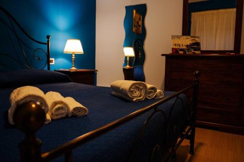 a bedroom with a bed with towels on it at Le Pernici Apartments in Mascalucia