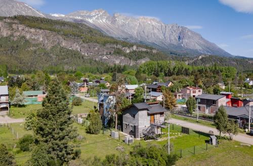 an aerial view of a village in the mountains at Origen Rent a house in El Bolsón