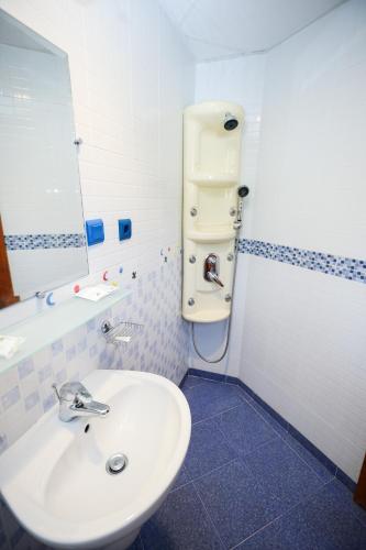 a bathroom with a white sink and a mirror at Zhivka House in Glavatartsi