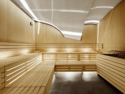 a sauna with wood paneling and a ceiling at ADLER Historic Guesthouse in Bressanone
