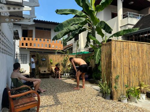 a group of people in a courtyard of a house at Chiangmai homestay in Chiang Mai