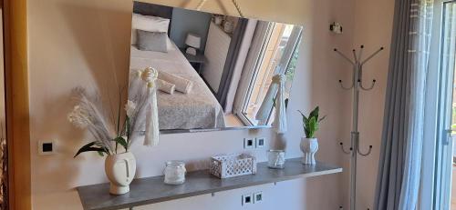 a mirror on a wall with a bed in a room at Modern Villa in Chania in Perivólia