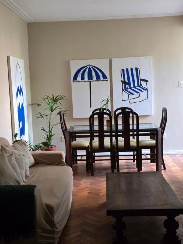 a living room with a dining room table and chairs at apartment cool & seafront Arpoador in Rio de Janeiro