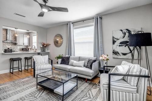 a living room with a couch and a table at Chic Waterfront Apartment in Downtown San Marco in Jacksonville