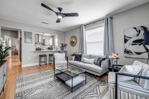 a living room with a couch and a table at Chic Waterfront Apartment in Downtown San Marco in Jacksonville