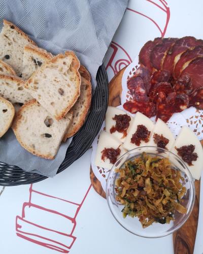 a table with a plate of food with bread and meats at Locanda dell'Angelo in Valle dellʼAngelo