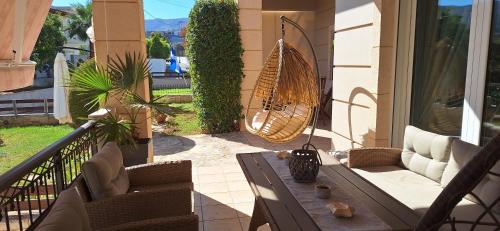 a patio with a table and chairs on a balcony at Modern Villa in Chania in Perivólia