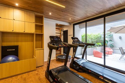 a gym with two treadmills in a room at Next Paulista by Viva - Apartamentos completos ao lado da Av Paulista e MASP in São Paulo
