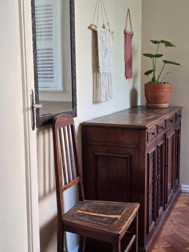 a wooden desk with a chair and a mirror at apartment cool & seafront Arpoador in Rio de Janeiro
