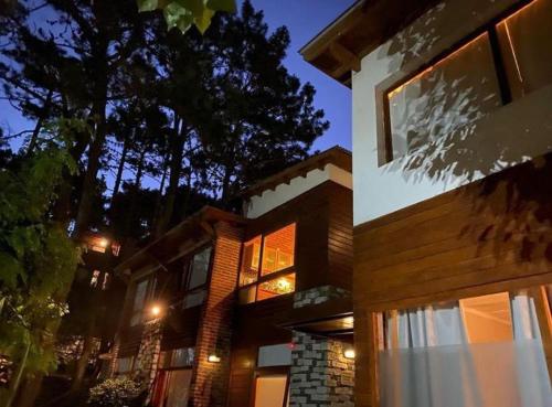 a large house with lights on the side of it at Avalon Apart in Mar de las Pampas