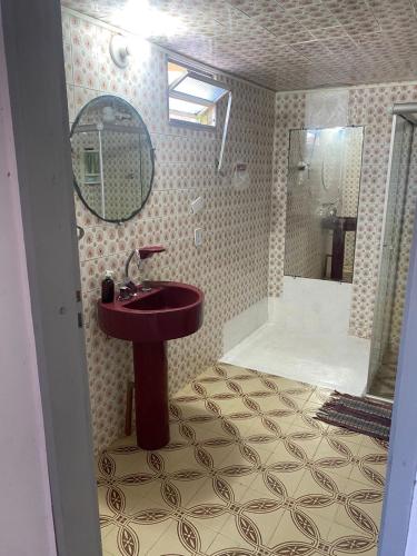 a bathroom with a sink and a shower with a mirror at Hospedagem Raiz Vida in Itacaré