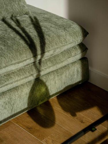 a shadow of a couch sitting on a wooden floor at Appartement Lumineux Bourg Saint Maurice in Bourg-Saint-Maurice