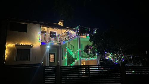 a house with christmas lights on it at night at Apartment Mare in Poreč