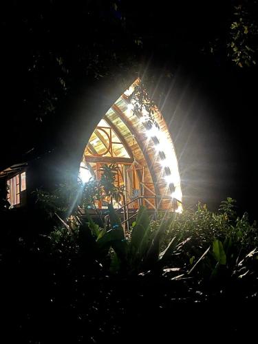 a tree house with a light in the dark at Sacha Urco Lodge y Bosque Protector in Mindo