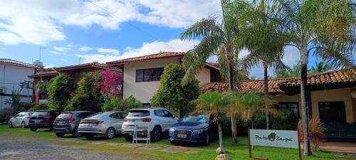 a group of cars parked in front of a building at Porto Zarpa Hotel in Praia do Forte