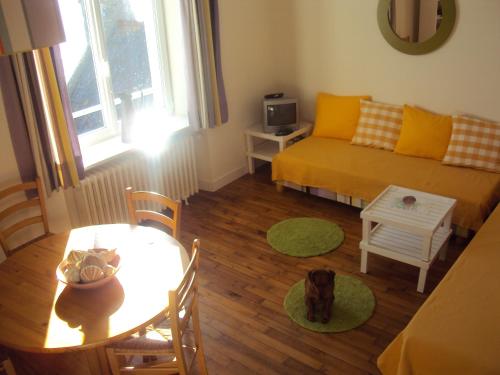 a living room with a couch and a table at petit poisson in Loctudy