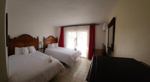Ein Bett oder Betten in einem Zimmer der Unterkunft Selva Boutique Hotel - Luquillo Oceanfront Retreat - Adults Only