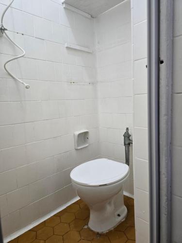 a bathroom with a white toilet in a room at apartment cool & seafront Arpoador in Rio de Janeiro