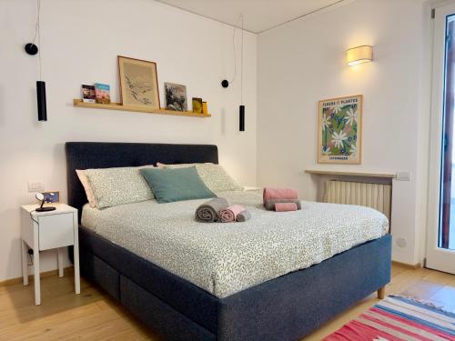 a bedroom with a bed with pillows on it at Casa di Bianca con Jacuzzi privata Riscaldata in Pedemonte