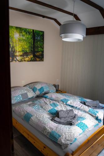 a bedroom with a bed with a quilt on it at Ferienwohnung zum Eiling in Bestwig