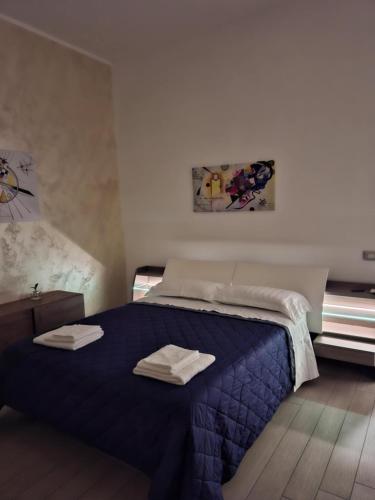 a bedroom with a bed with two towels on it at Alicja House in Casoria