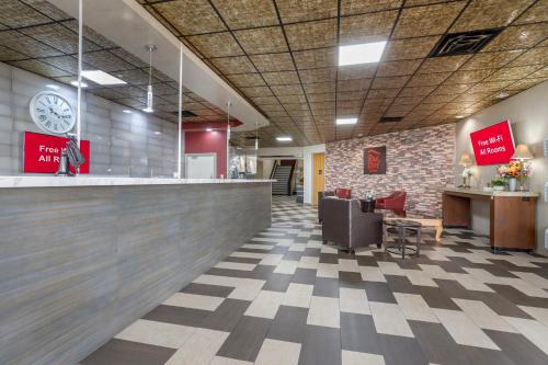 a lobby of a store with a clock on the wall at Red Roof Inn La Marque in La Marque