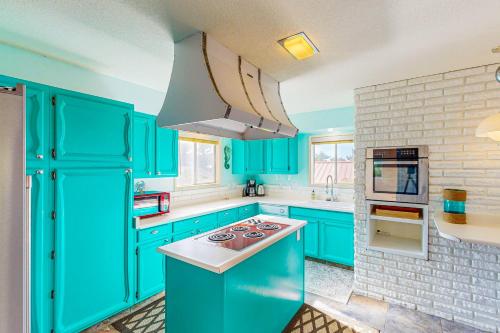 a blue kitchen with blue cabinets and a stove at Blue Waves Overlook in Newport