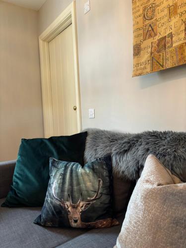 a couch with a pillow with a deer head on it at Ladyrath Lodge in Navan