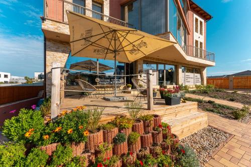a patio with plants and flowers on a house at LASKARA Garden Apartment by Prague Forest in Nové Jirny