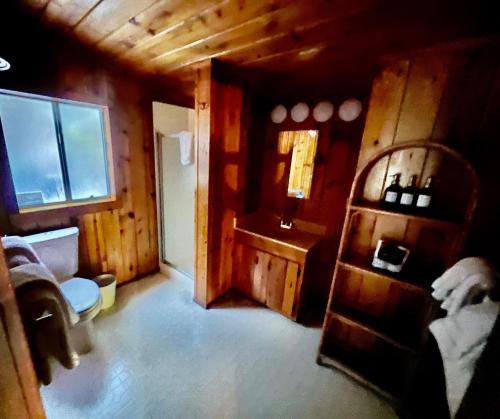 a room with a bathroom with a sink and a window at Fern River Resort in Felton