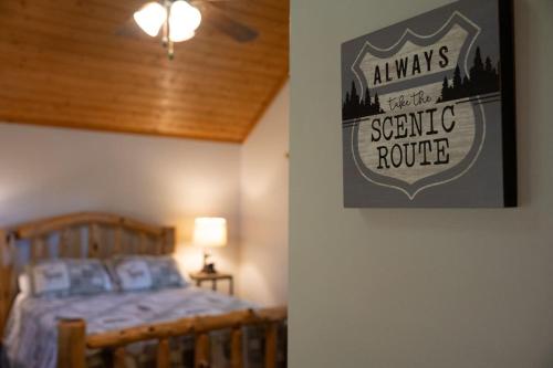 a bedroom with a bed and a picture on the wall at Secluded cabin convenient to Blairsville in Blairsville