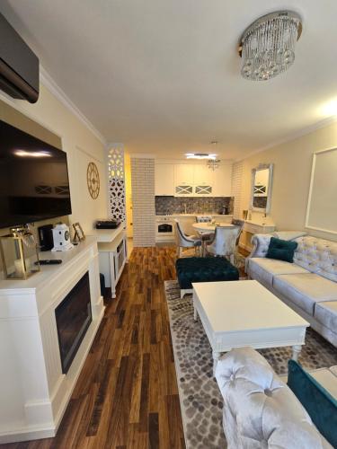 a living room with a couch and a table at Apartman DADO in Modriča