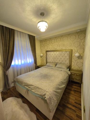 a bedroom with a bed and a window at Apartman DADO in Modriča