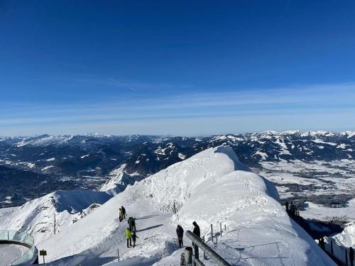 a group of people on top of a snow covered mountain at FEWO Allgäu Chalet mit Schwimmbad und Sauna in Oberstdorf