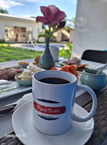 a cup of coffee on a plate on a table at Hotel La Guarida in Palma