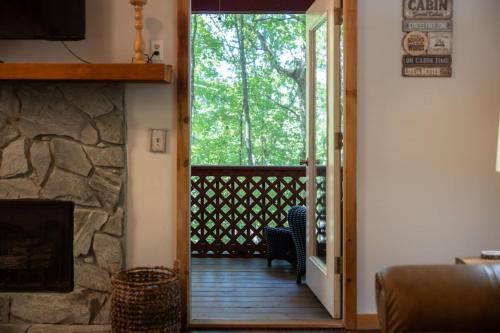 a living room with a door leading to a porch at Secluded cabin convenient to Blairsville in Blairsville