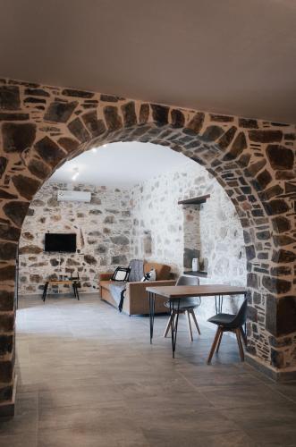 an archway in a room with a couch and a table at Lefteris Rooms in Kámbos