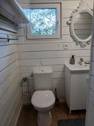 a white bathroom with a toilet and a sink at Chez Eve 2 in Nîmes