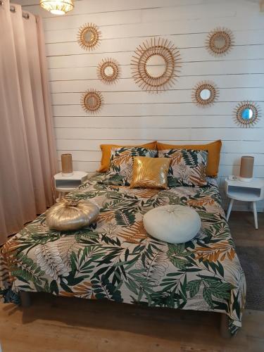 a bed with pillows on it in a bedroom at Chez Eve 2 in Nîmes