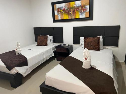 Postel nebo postele na pokoji v ubytování Hotel AMMA