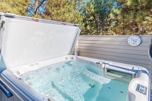 a hot tub with a clock on the side of it at Dogleg Retreat in Sunriver