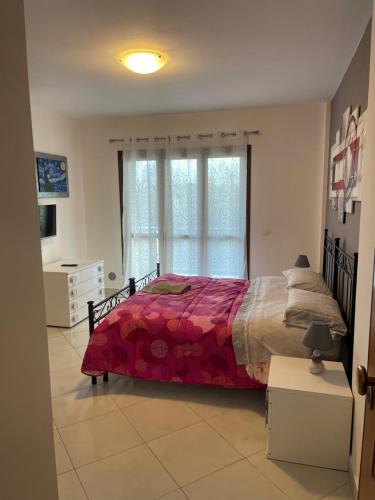 a bedroom with a large bed and a window at Affitta Camere DA MARIA 1 in Albiano