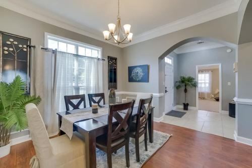 a dining room and living room with a table and chairs at Southern Comfort Oasis in Valdosta