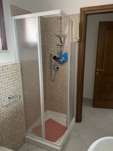 a shower with a glass door in a bathroom at Affitta Camere DA MARIA 1 in Albiano
