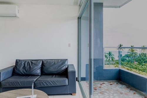 a living room with a couch and a table at Puerto Azul A1 52 in El Roble