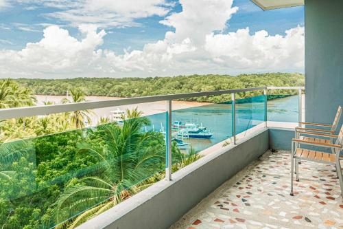 a balcony with a view of the water and a boat at Puerto Azul 153 in El Roble