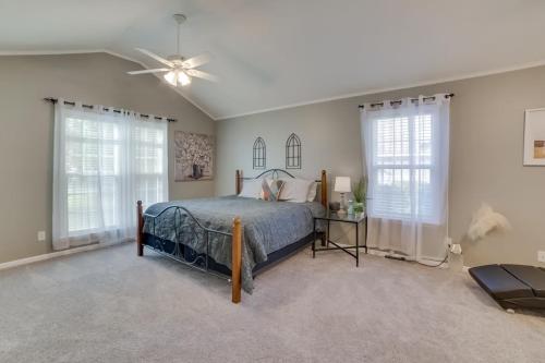 a bedroom with a bed and a ceiling fan at Southern Comfort Oasis in Valdosta