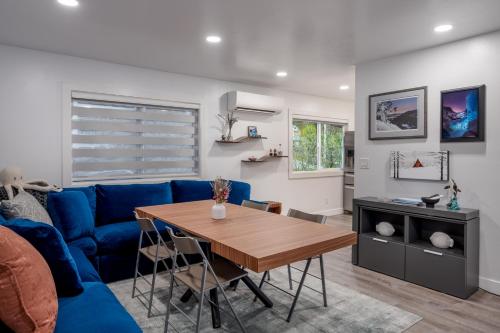 a living room with a blue couch and a table at Contemporary Alaska 2-bedroom Apartment in Juneau
