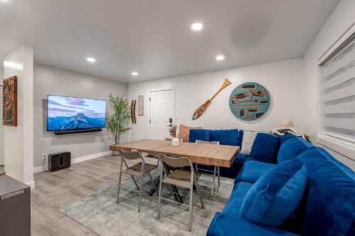 a living room with a blue couch and a table at Contemporary Alaska 2-bedroom Apartment in Juneau